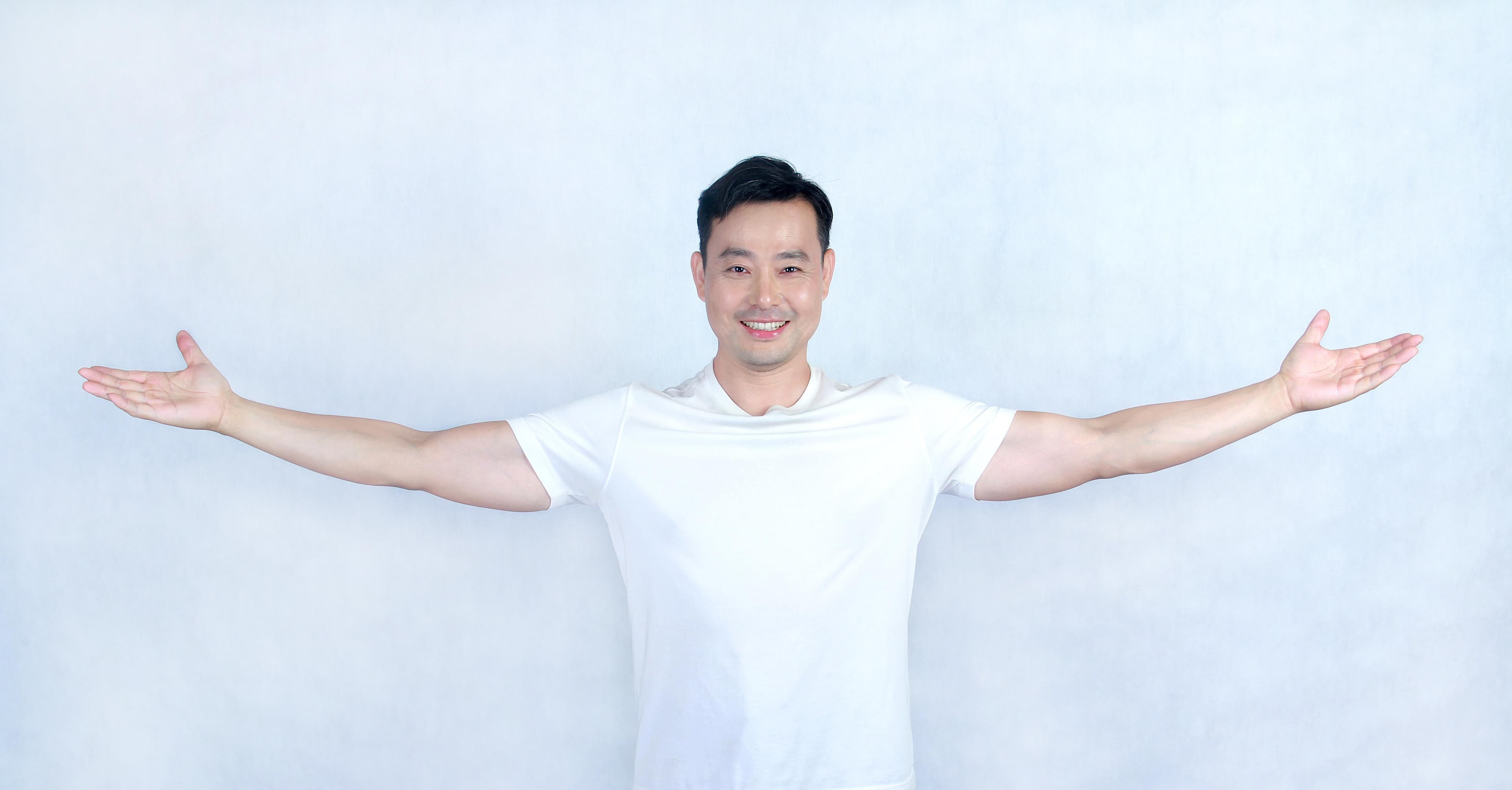 Kai smiling with both arms open