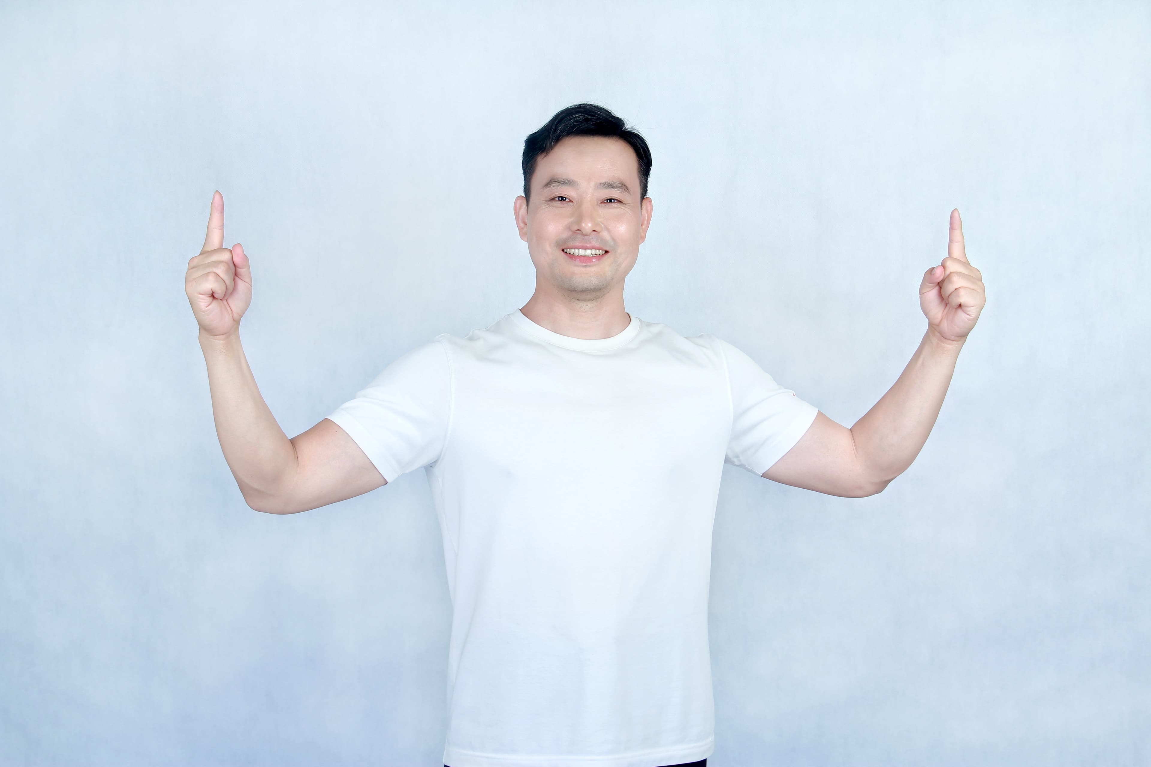 Kai pointing upward toward the two Mandarin course paths
